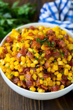 a white bowl filled with corn and bacon