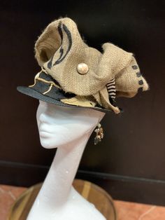 The art of the Zulu Hat. This hat is a cool classy look. It screams I'm Here. This is a wearable art hat. If you are looking for something Zulu, Kentucky Derby or just want to be different, this is the hat for you. This hat has 6 different looks. Every turn is a different look. Don't delay order yours today. Bohemian Gold Hat With Short Brim, Gold Bohemian Brimmed Hat, Bohemian Gold Hat For Kentucky Derby, Gold Bohemian Hat For Kentucky Derby, Curved Brim Costume Hat, Costume Hat With Curved Brim, Fitted Festival Costume Hat With Short Brim, Adjustable Cap For Costume, Adjustable Costume Cap