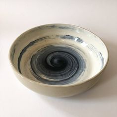 a black and white bowl sitting on top of a table