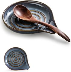 a wooden spoon sitting on top of a blue plate next to a bowl with swirl designs