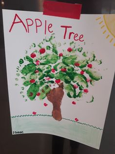 an apple tree is painted on a sign in front of a refrigerator door that says, apple tree