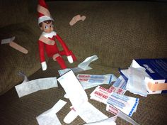 an elf is sitting on the couch next to some toilet paper and toothpaste