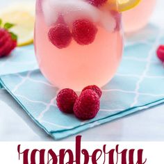 raspberry lemonade punch is garnished with fresh raspberries