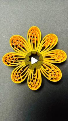 an origami flower is shown on a table