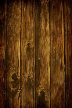 an old wooden wall with planks in the middle and dark wood at the top