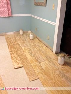 an empty room with hard wood flooring and blue walls