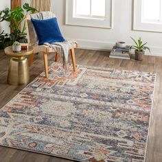 a living room area with a chair, rug and potted plants on the floor