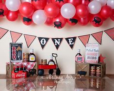 a birthday party with balloons and decorations on the wall, including an old fashioned tractor