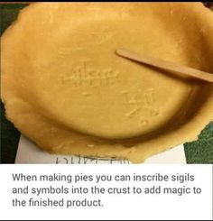 a pie crust with a wooden spoon in it and the words, when making pies you can inscribe signs and symbols in the crust to add magic to the finished product