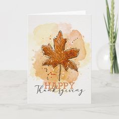 a happy thanksgiving card with a watercolor maple leaf