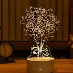 a vase with flowers is lit up on a table