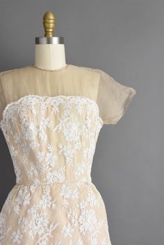 "Outstanding vintage 1950s cocktail party dress by Irene Sargent. This vintage dress features a wonderful Chantilly lace over lace with a gorgeous tier pencil skirt. The bodice is well fitted with bust darts, nipped waist, and a back metal zipper for closure. ✂------ M E A S U R E M E N T S ------- Best Fit: Small Bust: 32.5/33\" Waist: 24.5/25\" Hips: 37.5\" Shoulders: undefined Sleeves: 3.5\" Total Length: 44.5\" Tag/Label: Irene Sargent Material: Chantilly lace, silk Condition: Excellent vint Cream Party Dress With Delicate Lace, Cream Lace Dress For Party With Delicate Detailing, Cream Delicate Lace Dress For Party, 1950s Style Fitted Dresses With Lace Trim, Fitted 1950s Style Dress With Lace Trim, Cream Evening Dress With Scalloped Lace, Retro Lace Vintage Dress For Party, Vintage Lace Dress For Party In Retro Style, 1950s Cream Wedding Dress