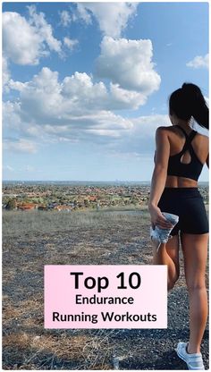 a woman standing on top of a dirt field