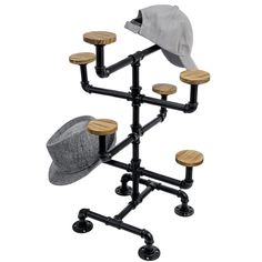 a hat is hanging on a rack with four wooden stools and a gray hat