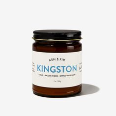 a jar of honey sitting on top of a white table