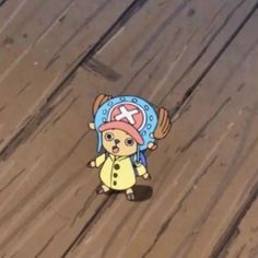 an animal with a pirate hat on standing in the middle of a wood plank floor