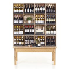 a display case with bottles of wine on it's sides and two wooden benches