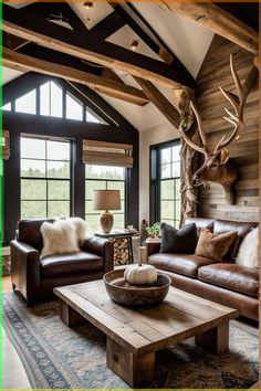 a living room filled with furniture and a deer head mounted on the wall