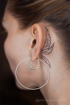 a woman with a tattoo on her ear