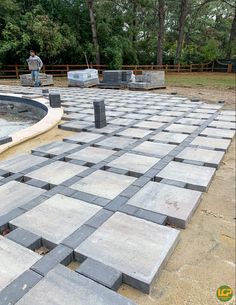 a man standing on top of a cement slab next to a pool