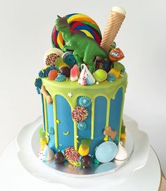 an image of a colorful cake with ice cream and candy on it's top