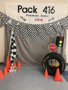 some cones and signs are set up in front of a banner