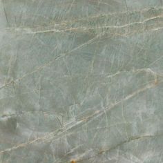 the marble is green and brown with some white streaks on it's surface,