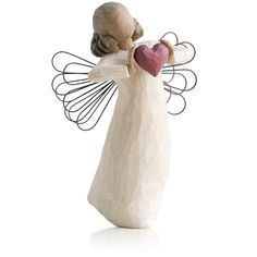 a ceramic angel holding a heart shaped object