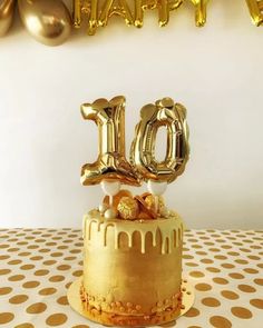 a golden birthday cake with the number 10 on it