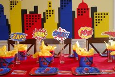 the table is set up for a superhero birthday party