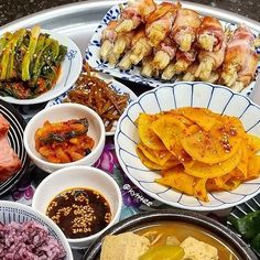 a tray filled with different types of food on top of a metal pan covered in sauces