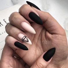 black and white stiled nails with geometric shapes on the tip of each nail, which are