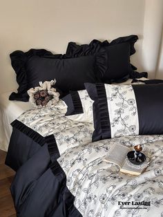 black and white bedding with ruffled trims on the comforter, pillows and pillow cases