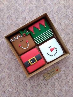 an open box filled with assorted decorated cookies