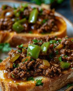 two pieces of bread with meat and peppers on them