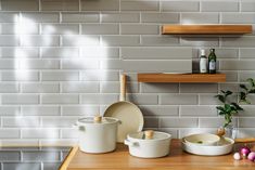 the kitchen counter is covered with dishes and utensils, including one for mixing