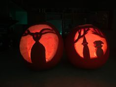 two pumpkins carved to look like they have shadows on them