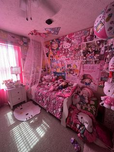 a bedroom with hello kitty decorations and pink walls