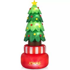 an inflatable christmas tree sitting on top of a red box with the word xmas written on it