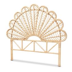 the headboard is made out of bamboo and has an intricate fan design on it