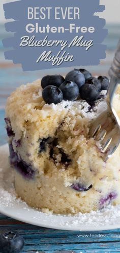 a piece of blueberry muffin on a plate with a fork