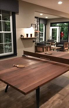 the table is made out of wood and has been placed in front of an open window