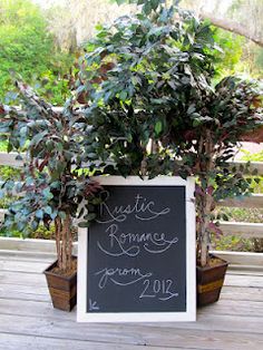 a chalkboard sign with some plants in it