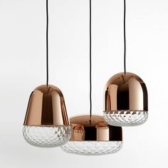 three lights that are hanging from the ceiling in different shapes and sizes, with one light turned on