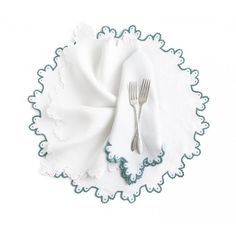 a white plate topped with a fork and napkin