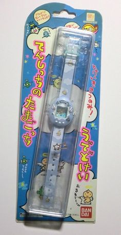 an electronic watch in its packaging on a white surface with japanese writing and cartoon characters