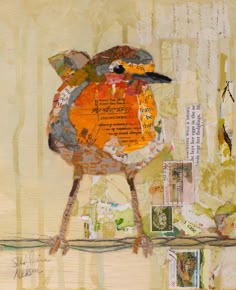 a bird sitting on top of a tree branch covered in lots of paper and stamps