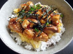 a white bowl filled with rice and meat