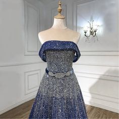 The striking blue hue exudes elegance and sophistication, making a statement at any event. Strapless design adds a touch of allure and showcases the shoulders beautifully. A-line silhouette offers a timeless and flattering fit, suitable for various body types. Embellished with beaded bling detailing, adding sparkle and glamour to the ensemble. Ideal for women's parties and special occasions, ensuring a captivating presence with refined luxury and style. Luxury Gown, Strapless Evening Dress, Dress 2024, Ladies Party, Blue Hues, Body Types, Evening Dress, Evening Dresses, Special Occasion