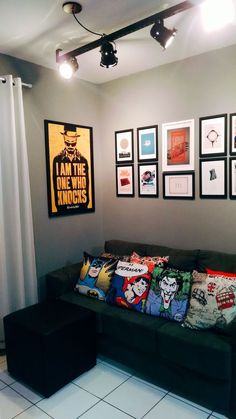 a living room filled with furniture and framed pictures on the wall above it's couch